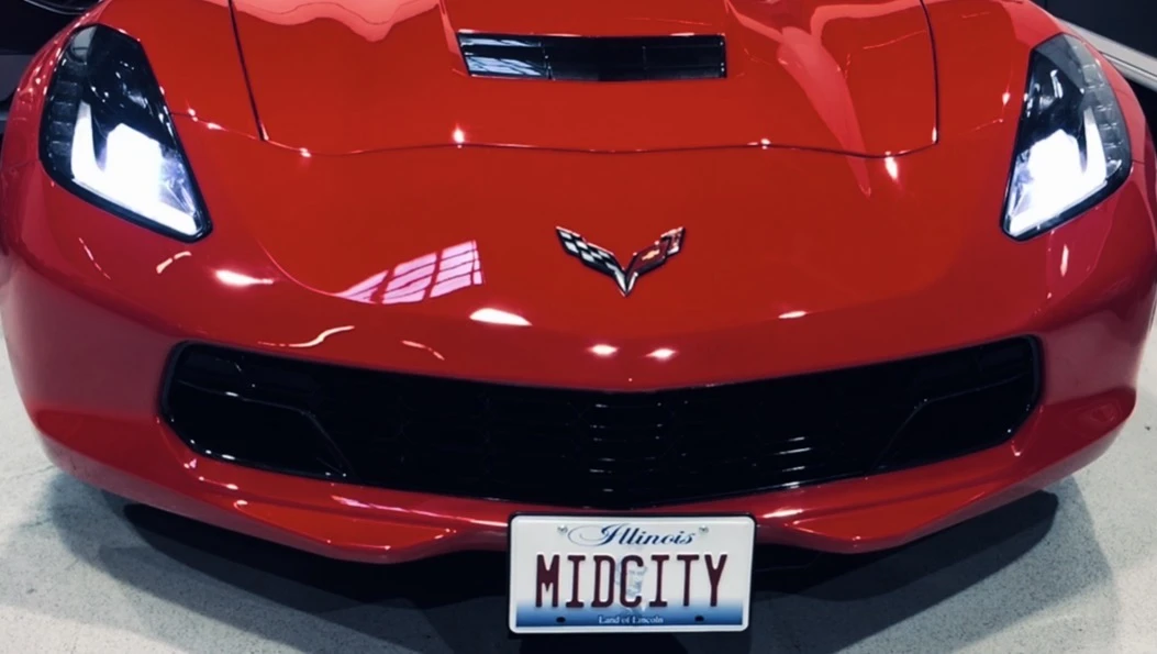Motorized retractable front license plate mechanism